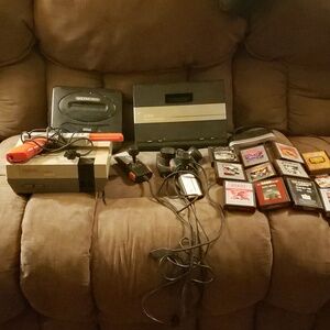 7800 atari with 12 games,  Nintendo nes.001 with duck hunter gun and sega genesi
